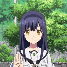 a girl with long blue hair and green eyes holds up her hand