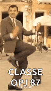 a man in a suit and tie is dancing on a sidewalk .