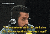 a man wearing headphones is talking into a microphone while talking about the list for the ballon d' or .