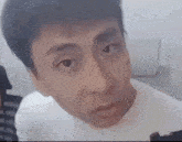 a close up of a man 's face looking at the camera