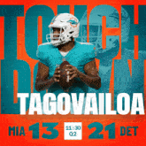 miami dolphins football player tagovailoa holds a football in his hands