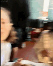 a blurry picture of a woman with the words margaritosgifs on the bottom