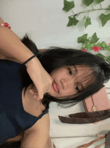 a girl is taking a picture of herself with a pink purse in the background
