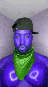 a man with blue face and a green bandana around his neck has the letter c on his chest .