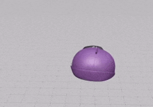 a purple ball is sitting on top of a grid on a table .