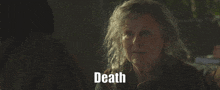 a woman in a dark room with the word death behind her