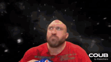 a man in a red shirt is eating a bag of coub