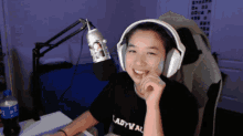 a woman wearing headphones and a black shirt that says lady val