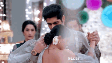 a man is putting a flower in a woman 's hair while they are dancing