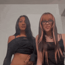 two girls are posing for a picture and one has glasses
