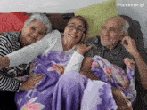 a family is sitting on a couch with a purple blanket and pixverse.ai written on the bottom