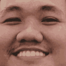 a close up of a person 's face with their mouth open and teeth showing .