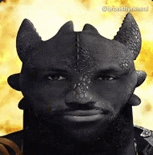 a man with a beard and horns is wearing a dragon costume .