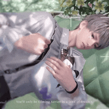 a man is laying on a green couch and the words you 'll only be filming xavier in a land of dreams