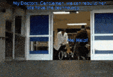 a doctor is talking to a man in a wheelchair in a hospital