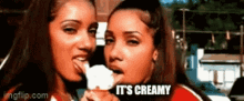 two women are eating an ice cream cone and the caption says it 's creamy .