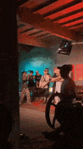 a group of people are standing on a stage in a room