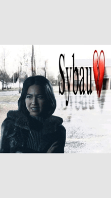 a woman is standing in front of a sign that says sybaum