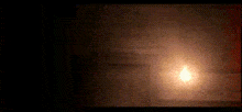 a close up of a person 's face with a glowing light behind them