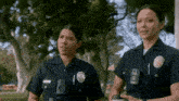 two female police officers standing next to each other