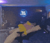 a person laying on a bed in front of a neon sign that says s & a