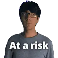 a man wearing glasses and a shirt that says at a risk on it