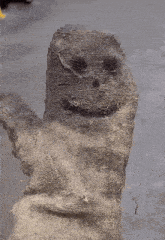 a close up of a dirty glove with a smiley face on it