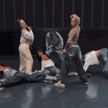 a group of people are dancing on a stage