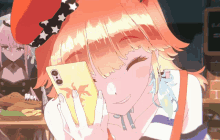 a girl with orange hair is holding a phone in her hand