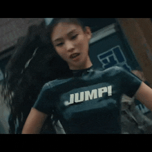 a woman wearing a black shirt that says jump