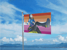 a flag with a picture of a person on it against a blue sky
