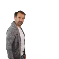 a man with a beard wearing a gray sweater and a white shirt