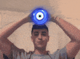 a man with a blue evil eye on his head
