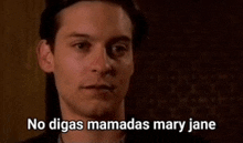 a close up of a man 's face with the words `` no digas mamadas mary jane '' written on it .