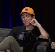 a man is wearing an orange hat that says labor