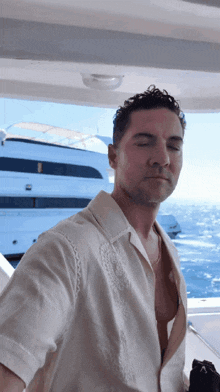 a man in a white shirt is standing on a boat