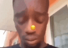 a close up of a man 's face with a smiley face on his nose .