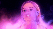 a close up of a woman 's face with purple smoke coming out of it