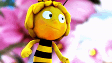 a yellow and black cartoon bee with a pink background