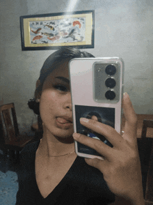 a woman is taking a picture of herself with her cell phone