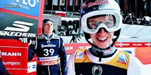 a man wearing goggles and a red bull helmet