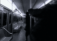 a black and white photo of a subway car with a sign on the wall that says ' tc '