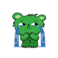 a green teddy bear is crying with tears coming out of its eyes