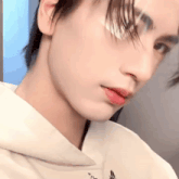 a close up of a young man 's face with red lipstick and a white shirt .