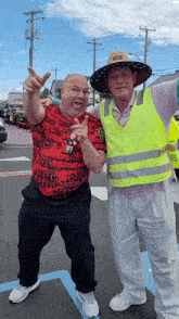 two men are posing for a picture and one is wearing a shirt that says chees