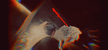 a person is laying on a bed holding a fan and a bunch of money .