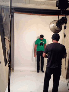 a man wearing a green shirt that says ' the indian chief ' on it