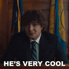 a man in a suit and tie with the words he 's very cool above him