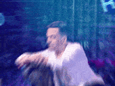 a blurry picture of a man holding a microphone in front of a sign that says a