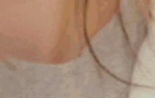 a close up of a woman 's face wearing a white jacket .